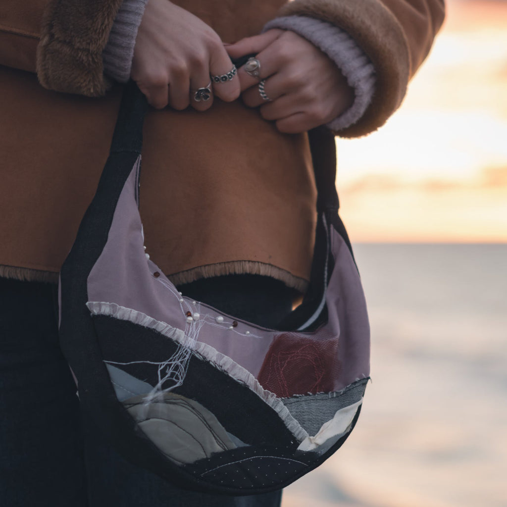 Durable white zipper and stitching detail on handmade upcycled tote bag, sustainable reversible handbag
