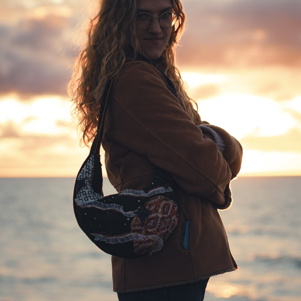 Handmade upcycled tote bag worn over shoulder, stylish reversible eco-friendly purse for daily use