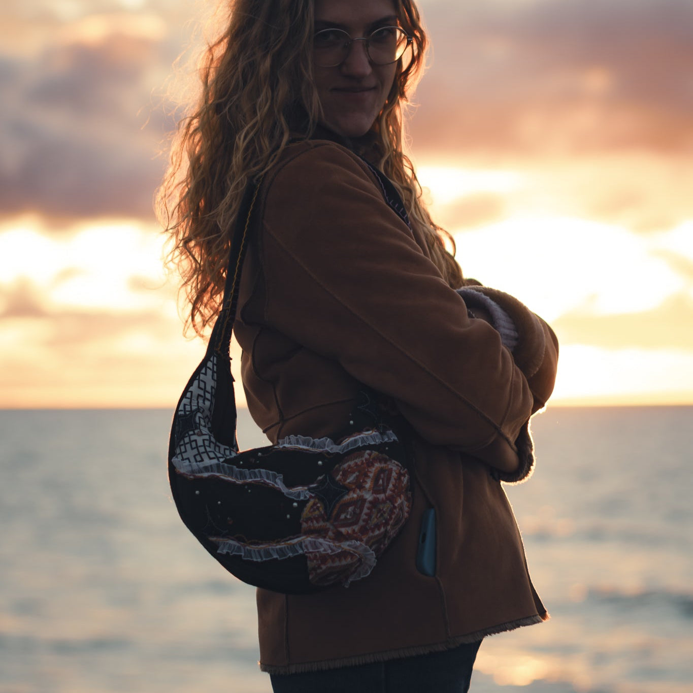 Handmade upcycled tote bag worn over shoulder, stylish reversible eco-friendly purse for daily use